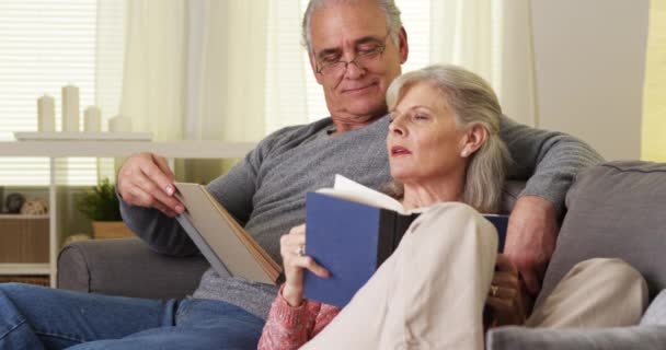 Elderly Couple Sitting Couch Reading Books — Stock Video