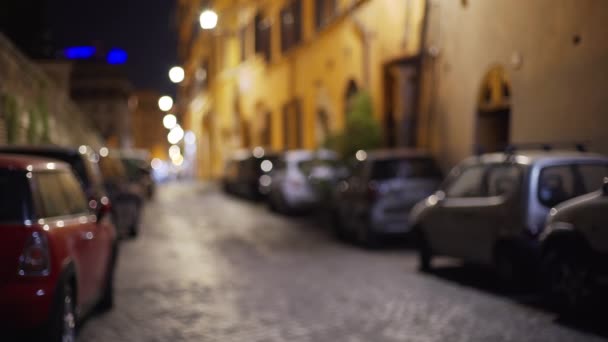 ヨーロッパで夜に駐車車と典型的な古い通り ローマの小さな通りに駐車車の並列の焦点の背景からイタリア — ストック動画