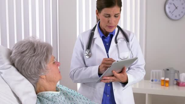 Senior Woman Doctor Taking Notes Tablet — Stock video