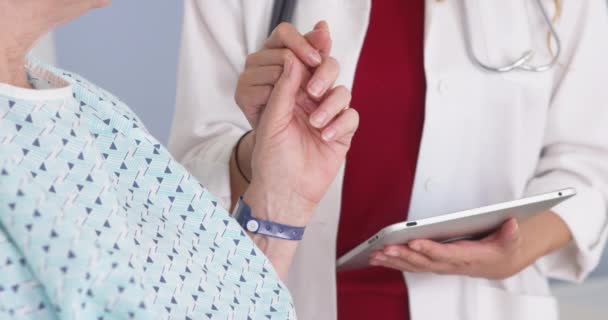 Japanese Doctor Holding Hand Elderly Female Patient — Stock Video