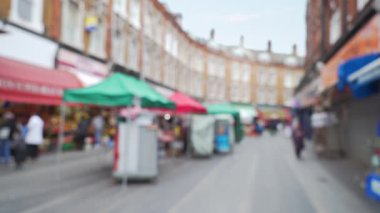 Brixton, Londra 'daki popüler sokak pazarının manzarası. Yerel halkın Londra 'nın ünlü eğlence merkezinden alışveriş yaparken çekilmiş görüntüleri. 4k