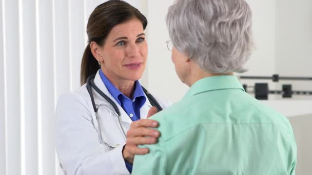 Senior Woman Doctor Putting Hand Patient Shoulder — Stock Video