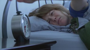 Sabahları yataktan kalkan bir kadın.