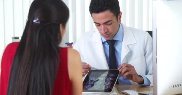 Hispanic Doctor Reviewing Brain Xrays Tablet Patient Desk — Stock Video