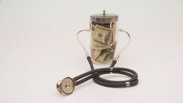 Jar Money Wearing Stethoscope — Stock Video