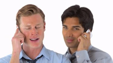 İki işadamı cep telefonlarıyla konuşuyor.