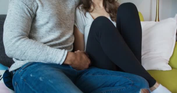 Young Millennial Couple Holding Hands Together Couch Camera Pans Find — Stock Video