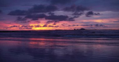 Kosta Rika 'daki plajda bulunan muhteşem turuncu, mor ve mavi günbatımının odak noktası dışında. Yeşil ekran bileşimi için okyanus güneşinin bulanık ya da odaksız görüntüsü. 4k