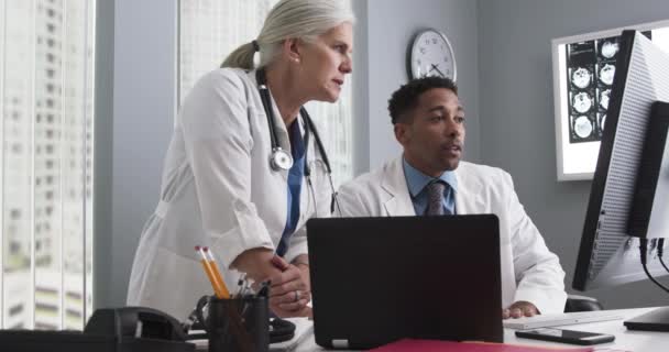 Portrait Millennial Black Doctor Using Computer While Senior Colleague Directs — Stock Video