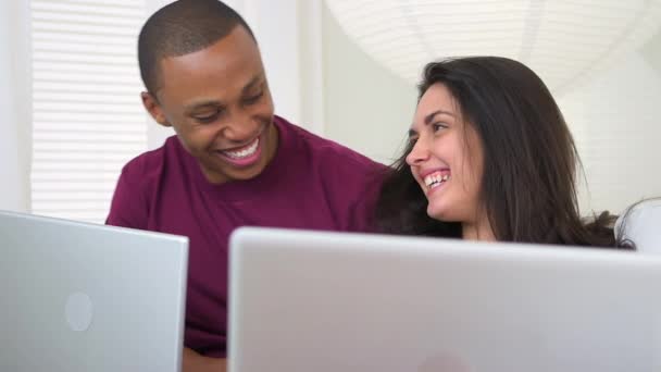 Interracial Couple Using Notebook Computers Couch — Stock Video