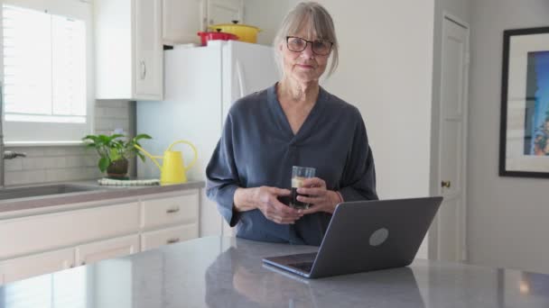 Dolly Shot Older White Woman Wearing Glasses Laptop Computer Kitchen — Video