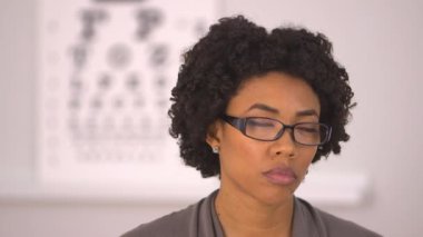 Afro-Amerikalı kadın göz doktorunda uyuyakalıyor.