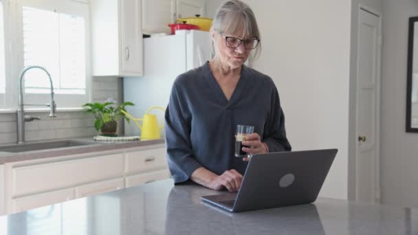 Dolly Shot Older Caucasian Woman Using Laptop Computer Kitchen While — Video
