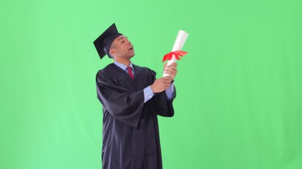 African American Man Graduation Gown Kissing Diploma — Stock Video