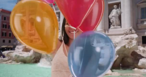 히스패닉 여자가 트레비 앞에서 핀으로 풍선을 던진다 로마를 아메리카 관광객 — 비디오