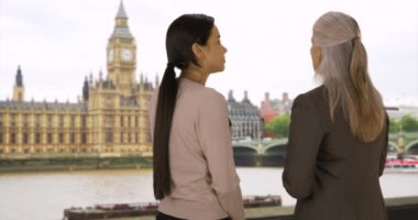 Big Ben yakınlarındaki iş ortakları Skyline 'a bakar ve gelecekteki gelişim planlarını tartışırlar. Başarılı iş kadını Thames Nehri 'nin yaratıcı fikirlerini paylaşıyor. 4k