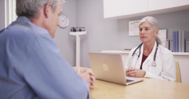 Beautiful Mature Medical Doctor Consulting Patient — Stock Video