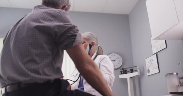 Intelligent Middle Aged Doctor Checking Patient Blood Pressure — Stock Video