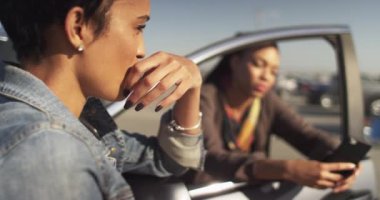 Güzel siyah kadın park yerinde takılırken en iyi arkadaşıyla konuşuyor.