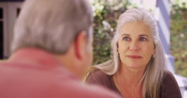 Çekici, olgun, beyaz bir kadın erkek arkadaşıyla konuşuyor. Son sınıf arkadaşlarının birbirleriyle konuştuğu yakın çekim..