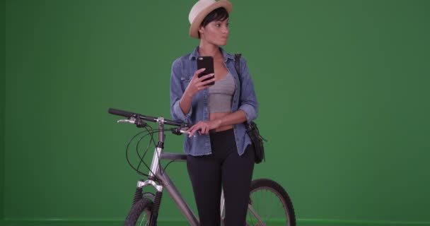 黒人女性は自転車に乗り 緑の画面上のスマートフォンでテキストメッセージを送る 緑の画面でキーまたは構成されます — ストック動画