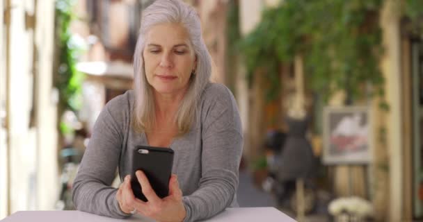 Casual Older Caucasian Female Uses Her Smartphone While Sitting European — Stock Video