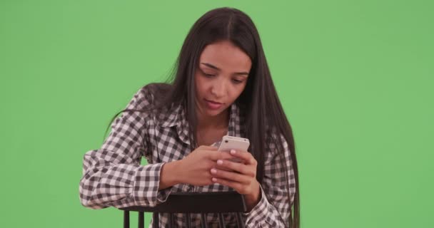 Fiatal Latina Hátrafelé Székében Telefonján Zöld Képernyőn Zöldfelületen Karcolt Vagy — Stock videók