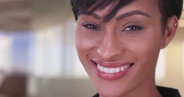İçerde kameraya bakan mutlu, gülümseyen siyah kadın. 20 'li yaşlarındaki güzel Afro-Amerikan milenyumuna yakın..