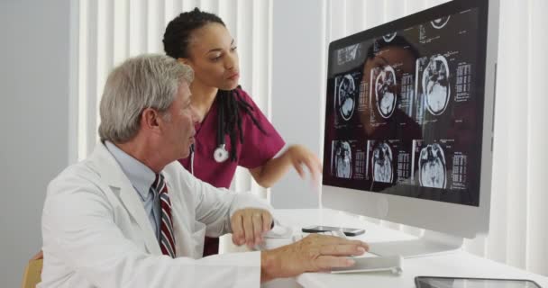 Two Doctors Reviewing Patient Brain Ray — Stock Video