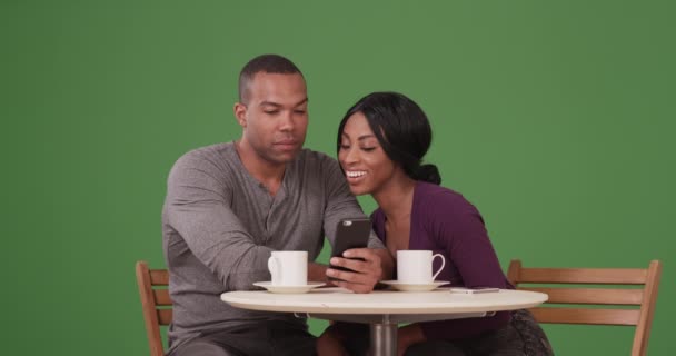 快乐的黑人夫妇使用手机 在绿色屏幕上喝咖啡 在绿色屏幕上键入或合成 — 图库视频影像