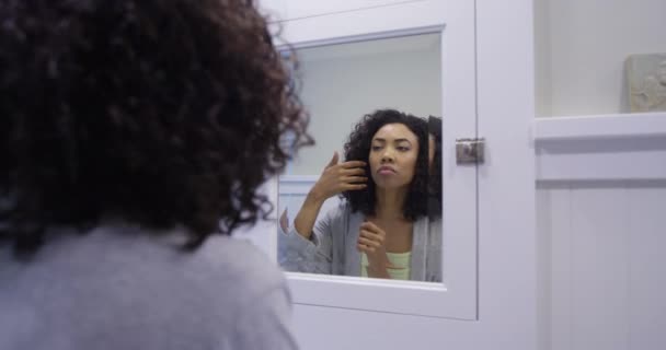 Black Woman Fixing Hair Bathroom — Stock Video