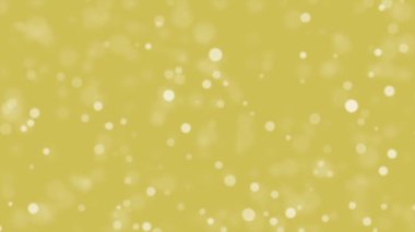 Golden festive animated background with falling bokeh light particles.