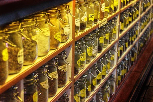 close view of small bottles of spices on shelves in the store.