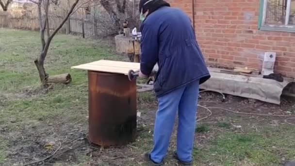 Master works with a grinder on the wood outdoors, video — Stock Video