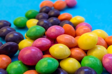 Multicolored sweet fruit candies in a hard shell.