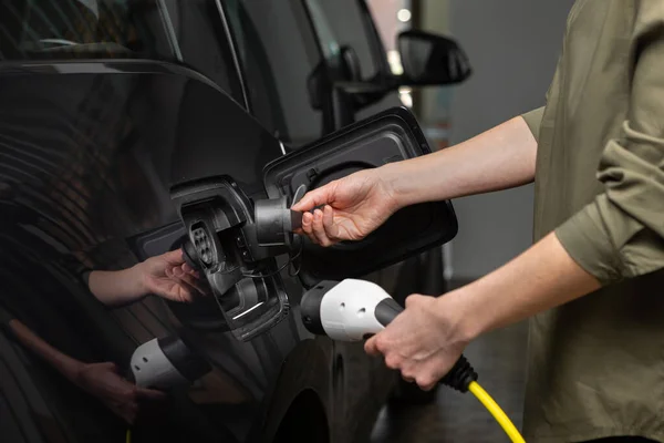 Close Up Of Womans handen verwijderen van het deksel van een elektrische auto thuis. — Stockfoto