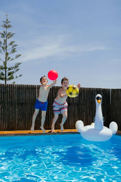 Two Boys Play Ball Jump Blue Water Pool Sunny Day — Stock Photo, Image