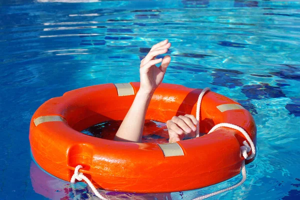 Red Lifebuoy Surface Water Pool Hands Man Grabbing Close Saving Royaltyfria Stockfoton