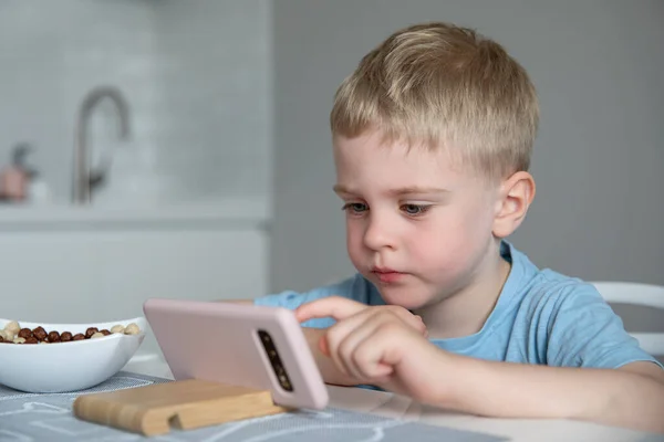 Leuk Jongetje Blond Kijkt Naar Smartphone Zittend Keuken Thuis Eet — Stockfoto