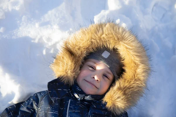 Cute Smiling Boy Hat Hood Fur Lies Snow Having Fun — Stock Photo, Image