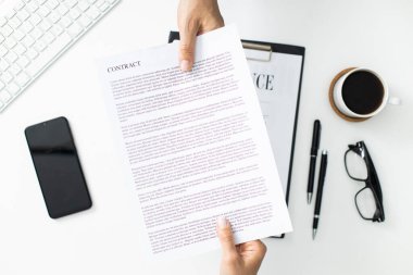 İş adamı ve işkadını sözleşme ya da belge değiş tokuşu yapıyor. Ofis masası üst görünümü