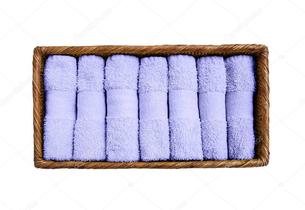 Lilac towels in basket isolated over white background. Color of the year 2022 Very peri