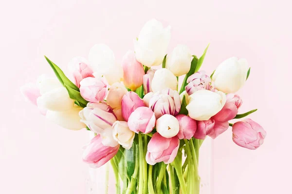 Pink and white tulips bouquet on a pink background. Valentines Day, Mothers Day, birthday concept.