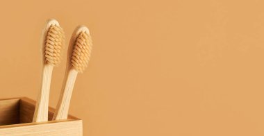 Bambu diş fırçaları kahverengi arka plandaki bambu tutacağında. Çevre dostu, sıfır atık kavramı