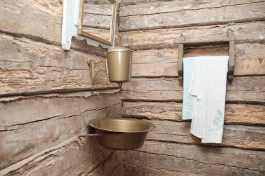 Ahşap bir duvarda eski metal bir leğen..