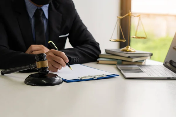 judge, male lawyer, business consultant legal services and consulting in various contracts to plan a court case hammer and scales of justice Businessman in a suit working on paperwork. Law