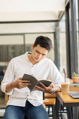 Kütüphanede dizüstü bilgisayarda kitap okuyan bir çocuk ödevini yap ve bilgisayarını daktilo et. Bir kafede çevrimiçi bilgisayar dersleri hakkında bir web sitesi izleyin. Eğitici kavram