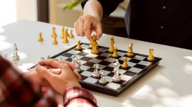 Businessman moving chess pieces on chess board game concept for competition and strategy. business success concept, business competition planning