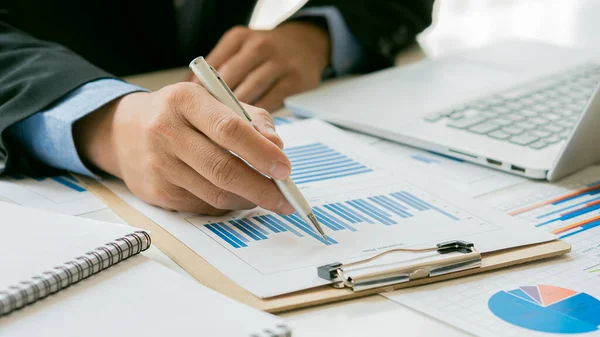 Businessman Holding Pen While Reading Statistics Graph His Desk Office — Stok fotoğraf