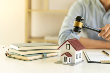 real estate agent holding a hammer to break the house Buying and Finance Approval Ideas